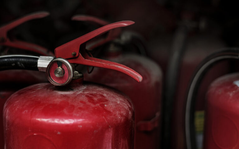 Row of red portable fire extinguishers